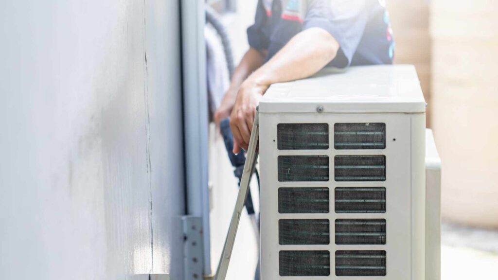 technician checking on air conditioner in Kyle TX